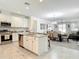 Bright kitchen with a center island and stainless steel appliances overlooking the dining area at 12687 Retreat Pl, Spring Hill, FL 34610