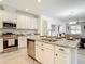 Modern kitchen featuring granite countertops, a center island, and stainless steel appliances at 12687 Retreat Pl, Spring Hill, FL 34610