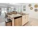 Open kitchen island with granite countertops, stainless steel dishwasher, and seating at 12687 Retreat Pl, Spring Hill, FL 34610