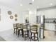 Spacious kitchen island with barstool seating and stainless steel refrigerator at 12687 Retreat Pl, Spring Hill, FL 34610