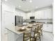 Bright kitchen island with granite countertop, seating, and modern appliances at 12687 Retreat Pl, Spring Hill, FL 34610