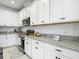 Well-lit kitchen showcasing stainless steel appliances and granite countertops at 12687 Retreat Pl, Spring Hill, FL 34610
