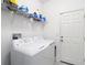 Practical laundry room with washer, dryer, and shelving, making laundry tasks convenient and organized at 12687 Retreat Pl, Spring Hill, FL 34610