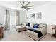 Cozy living room with a plush gray sectional, elegant wall decor, and a modern ceiling fan at 12687 Retreat Pl, Spring Hill, FL 34610