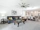 Open concept living space with sofa, dining area, and stylish decor, perfect for entertaining guests at 12687 Retreat Pl, Spring Hill, FL 34610