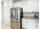 Stainless steel refrigerator with water dispenser and white cabinets at 12687 Retreat Pl, Spring Hill, FL 34610