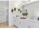Bright bathroom with double vanity, stylish mirrors, and walk-in glass shower at 13548 Tropical Breeze Way, Hudson, FL 34669