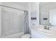 Clean and bright bathroom featuring a shower-tub combo, modern sink, and neutral finishes at 13548 Tropical Breeze Way, Hudson, FL 34669