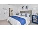 Bright bedroom featuring a woven headboard, elegant bedside tables, and ensuite bathroom access at 13548 Tropical Breeze Way, Hudson, FL 34669