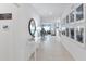 Spacious hallway leading to living area, featuring modern decor and light tile flooring at 13548 Tropical Breeze Way, Hudson, FL 34669