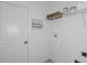 Functional laundry room with storage shelves and whimsical design elements at 13548 Tropical Breeze Way, Hudson, FL 34669