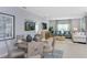 Inviting living room with open layout, dining area, comfortable seating, and contemporary decor at 13548 Tropical Breeze Way, Hudson, FL 34669