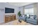 Cozy living room area with modern furniture, a flat-screen TV, and stylish decorations at 13548 Tropical Breeze Way, Hudson, FL 34669