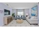 Comfortable living room featuring stylish furniture, a large TV, and plenty of natural light at 13548 Tropical Breeze Way, Hudson, FL 34669