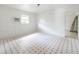 Bright bedroom with square pattern flooring, a window, and air conditioning unit at 1406 E Holland Ave, Tampa, FL 33612
