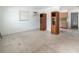 The bright living room features neutral walls, flooring and vintage wood cabinets for storage at 1406 E Holland Ave, Tampa, FL 33612