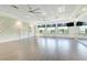 Large activity room featuring ceiling fans, wall mirrors, natural light and decorative trim at 15525 Corona Del Mar Dr, Wimauma, FL 33598