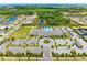 Aerial view showing expansive parking lot at the community recreation center and clubhouse at 15525 Corona Del Mar Dr, Wimauma, FL 33598
