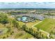 Aerial view of the expansive recreation center with a pool and well-manicured grounds at 15525 Corona Del Mar Dr, Wimauma, FL 33598