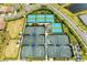 Aerial view of tennis and sports courts with manicured landscaping and facilities at 15525 Corona Del Mar Dr, Wimauma, FL 33598