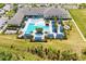 Aerial view shows sparkling community pool, cabanas, grilling area and meticulous landscaping at 15525 Corona Del Mar Dr, Wimauma, FL 33598