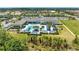 Birds-eye view showcases community recreation center with pool, cabanas, and lush landscaping at 15525 Corona Del Mar Dr, Wimauma, FL 33598