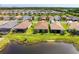 Aerial shot of homes backing onto a peaceful lake, complete with screened patios at 15525 Corona Del Mar Dr, Wimauma, FL 33598