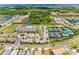 Aerial view features the community recreation center, pool, tennis courts, and greenery at 15525 Corona Del Mar Dr, Wimauma, FL 33598