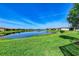 A backyard view overlooking the serene lake, offering tranquility and picturesque scenery at 15525 Corona Del Mar Dr, Wimauma, FL 33598