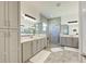 Bathroom featuring double vanities, a large shower, and modern lighting fixtures at 15525 Corona Del Mar Dr, Wimauma, FL 33598