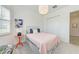 Cozy bedroom with white walls, large windows, and a stylish bed, creating a calming retreat at 15525 Corona Del Mar Dr, Wimauma, FL 33598
