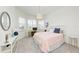 Bedroom with bay window, desk, round mirror, pendant light, and a comfortable, inviting atmosphere at 15525 Corona Del Mar Dr, Wimauma, FL 33598