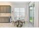 Bright breakfast nook with modern round table, stylish seating and shuttered window at 15525 Corona Del Mar Dr, Wimauma, FL 33598