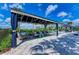 Relaxing cabana with comfortable seating, offering a shaded retreat by the pool at 15525 Corona Del Mar Dr, Wimauma, FL 33598
