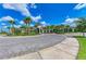 Beautiful clubhouse entrance with brick paved circular driveway and verdant landscaping at 15525 Corona Del Mar Dr, Wimauma, FL 33598