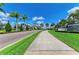 Scenic view of community entrance featuring lush greenery and elegant landscaping at 15525 Corona Del Mar Dr, Wimauma, FL 33598