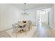 Elegant dining area with modern chandelier, leading to the entryway at 15525 Corona Del Mar Dr, Wimauma, FL 33598