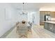 Stylish dining room with gray cabinets, open to a modern kitchen and island at 15525 Corona Del Mar Dr, Wimauma, FL 33598