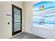 Entrance to the exercise and ping pong room with beach themed artwork on the wall at 15525 Corona Del Mar Dr, Wimauma, FL 33598