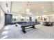 Spacious game room with multiple pool tables and seating areas at 15525 Corona Del Mar Dr, Wimauma, FL 33598