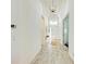 Inviting hallway with tiled floors, leading to the home's entrance and living areas at 15525 Corona Del Mar Dr, Wimauma, FL 33598