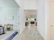 Bright hallway leading to an open-concept living space with views of the lake at 15525 Corona Del Mar Dr, Wimauma, FL 33598