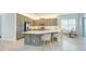 Modern kitchen with gray cabinetry, center island, and stylish seating at 15525 Corona Del Mar Dr, Wimauma, FL 33598