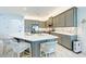 Spacious kitchen with a center island, gray cabinets, and stainless steel appliances at 15525 Corona Del Mar Dr, Wimauma, FL 33598