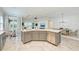 Kitchen island with stainless steel dishwasher and seating for dining and entertaining at 15525 Corona Del Mar Dr, Wimauma, FL 33598