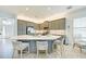 Beautiful kitchen features gray cabinets, a large island, and stainless steel appliances at 15525 Corona Del Mar Dr, Wimauma, FL 33598