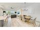 Open-concept living room features modern decor, lake views, and dining area at 15525 Corona Del Mar Dr, Wimauma, FL 33598