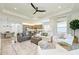 Open-concept living space connects the living room, dining area, and kitchen at 15525 Corona Del Mar Dr, Wimauma, FL 33598