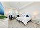 Comfortable main bedroom with a chandelier, white bedding, and soft, natural light at 15525 Corona Del Mar Dr, Wimauma, FL 33598