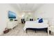 Airy bedroom with a plush bed, blue accent pillows, and a view of the outdoors at 15525 Corona Del Mar Dr, Wimauma, FL 33598